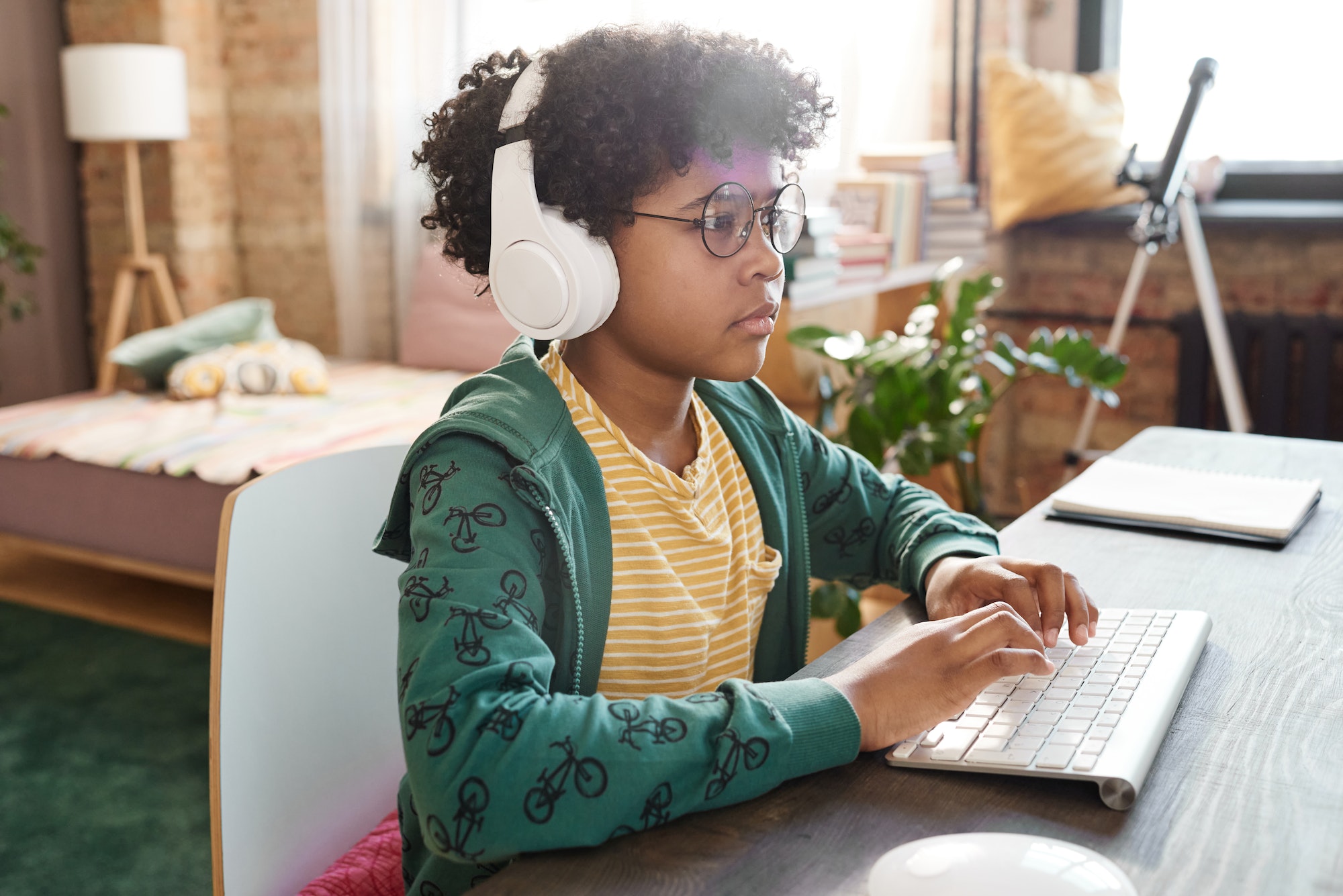 African kid using computer for online game