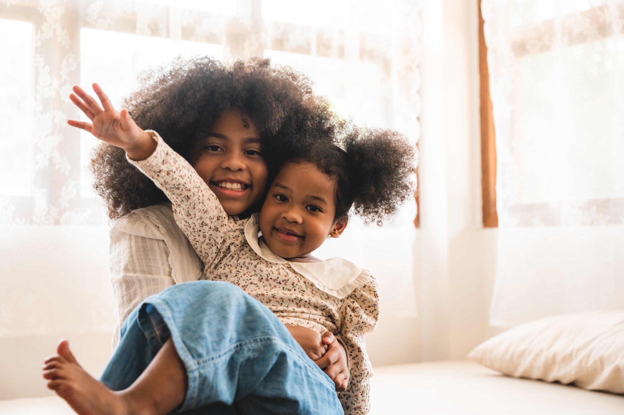 American African children playing on the bed, live at home